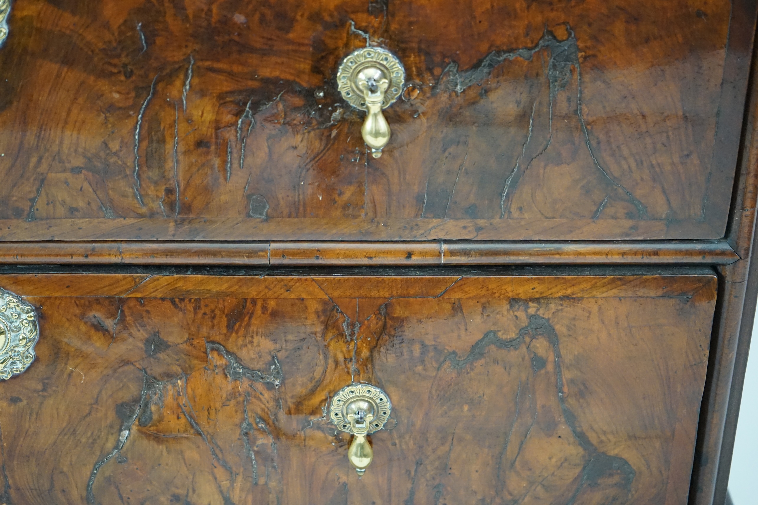 An early 18th century and later crossbanded walnut chest on stand